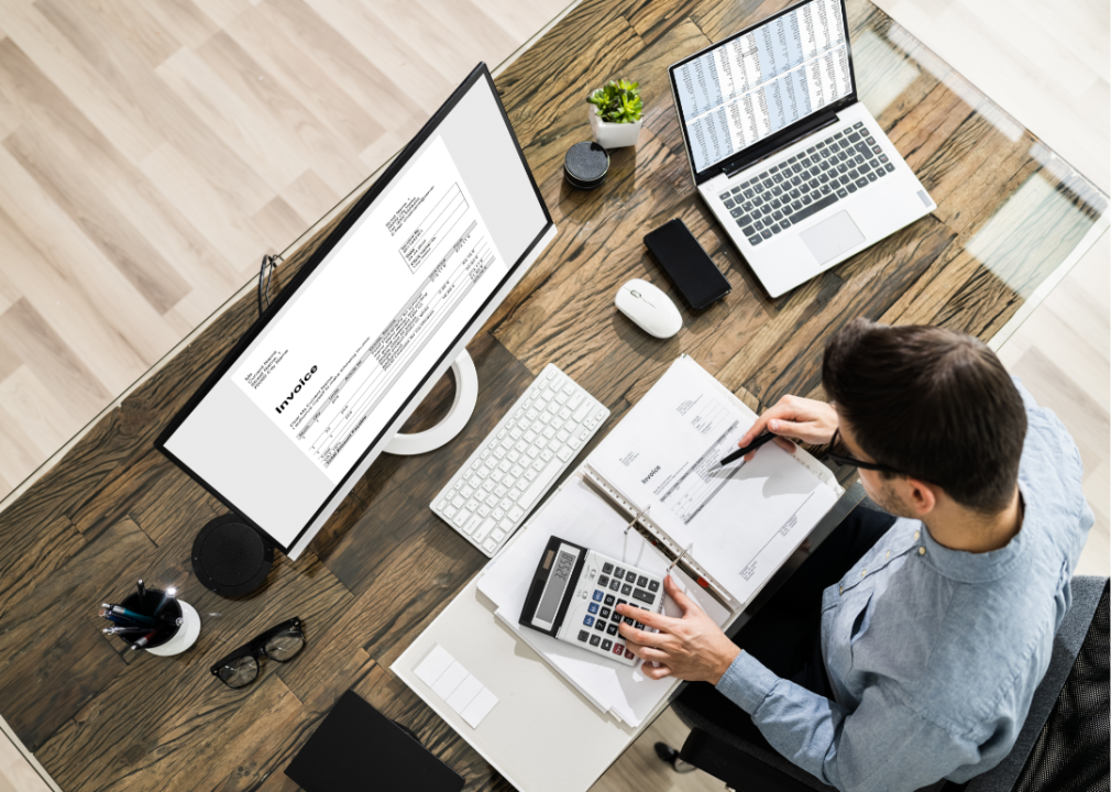 Overhead view of an accountant working at a desk.