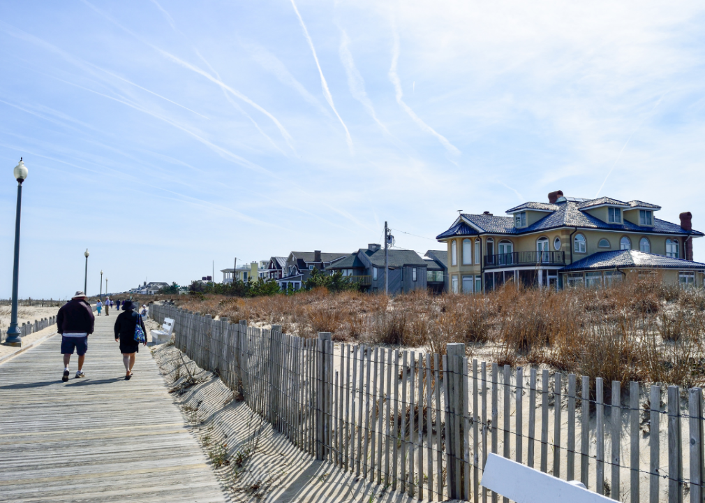 Two people walking on the boardwalk in Rehoboth Beach, Delaware