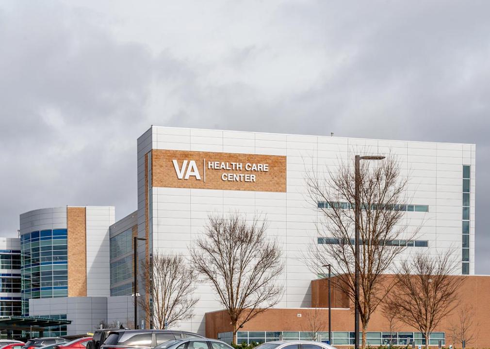 VA Healthcare center as seen from the parking lot in Charlotte, NC with overcast clouds in the background.