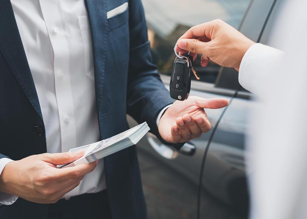 A car buyer receives the car keys to his purchase.