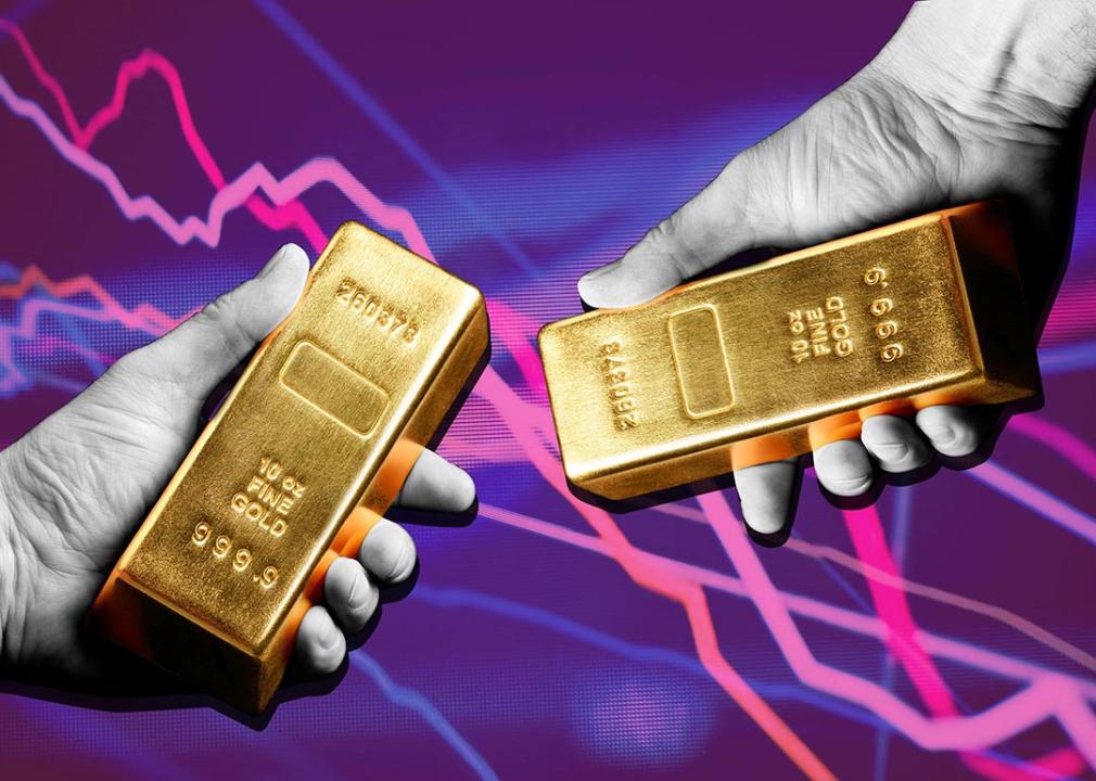 Photo illustration of black and white hands holding gold bars with purple background. 