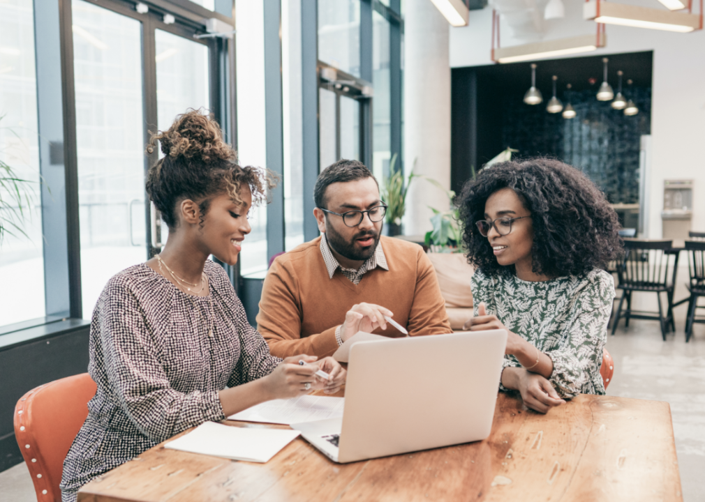 A young couple consults with an advisor about real estate investment.