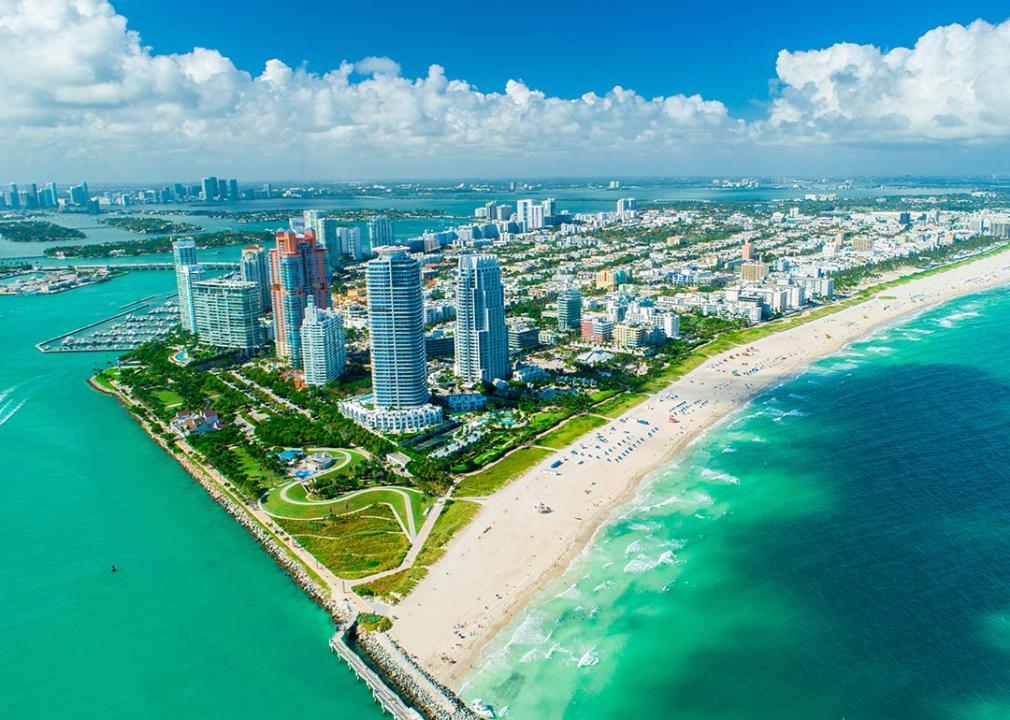 An aerial view of the blue-green ocean and skyline of South Beach, Miami. 