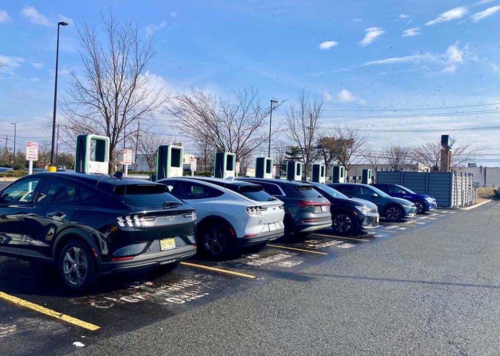 A row of electric cars charging at stations in a Walmart in New Jersey.