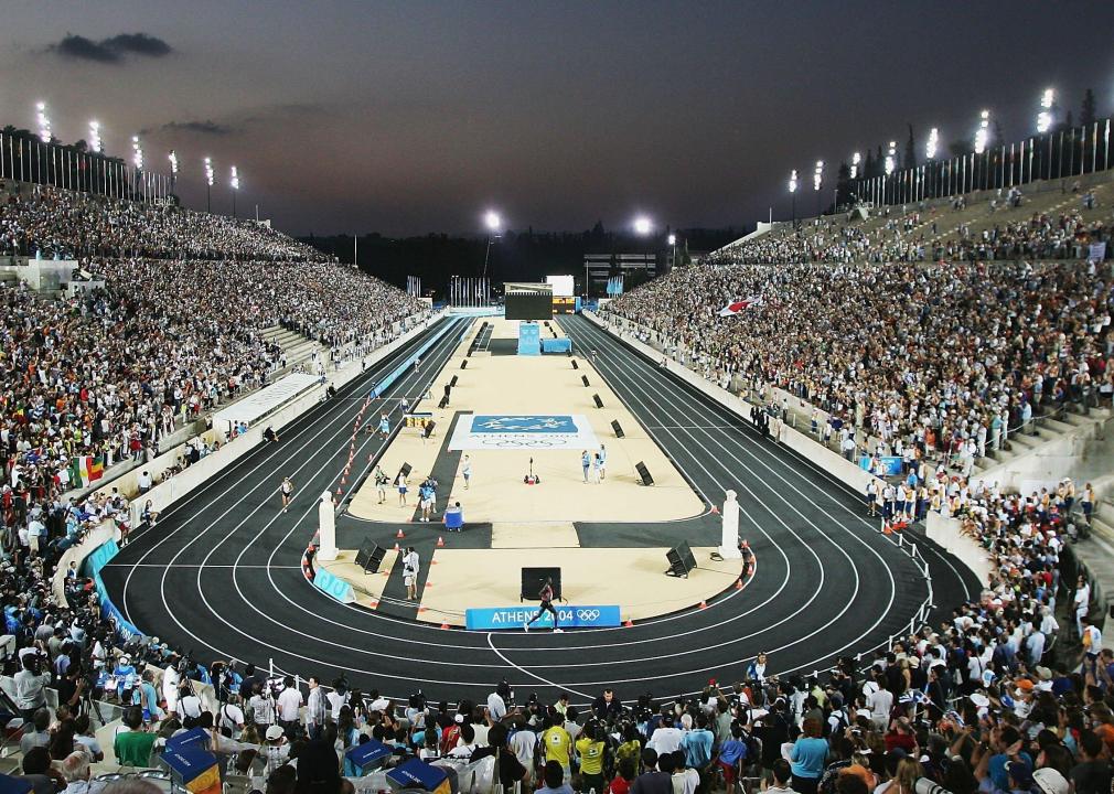 Runners enter the stadium and near the finish during the men's marathon.