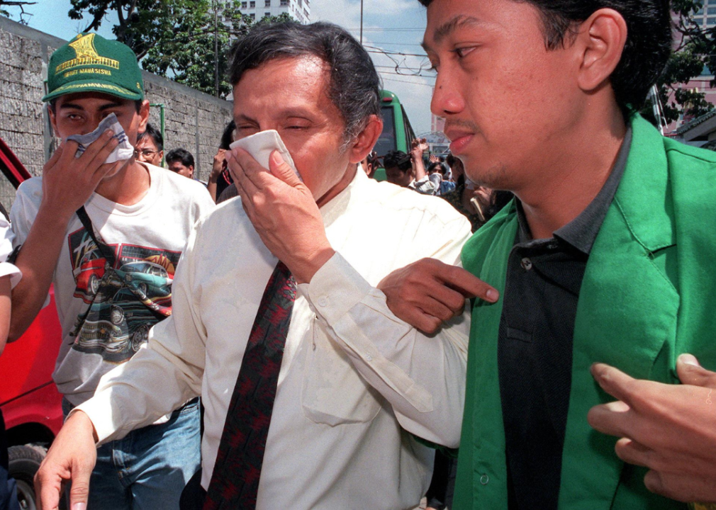 People cover their mouths and noses with hankerchiefs. 