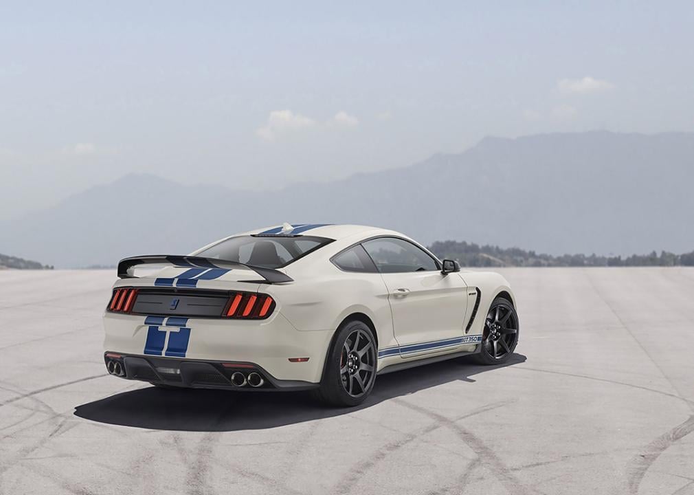 A white and blue Ford Mustang Shelby GT350 parked showcasing its rear view.