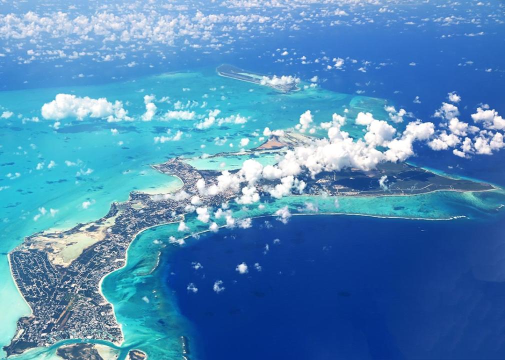 Aerial view of Turks and Caicos surrounded by turquoise and deep blue sea.