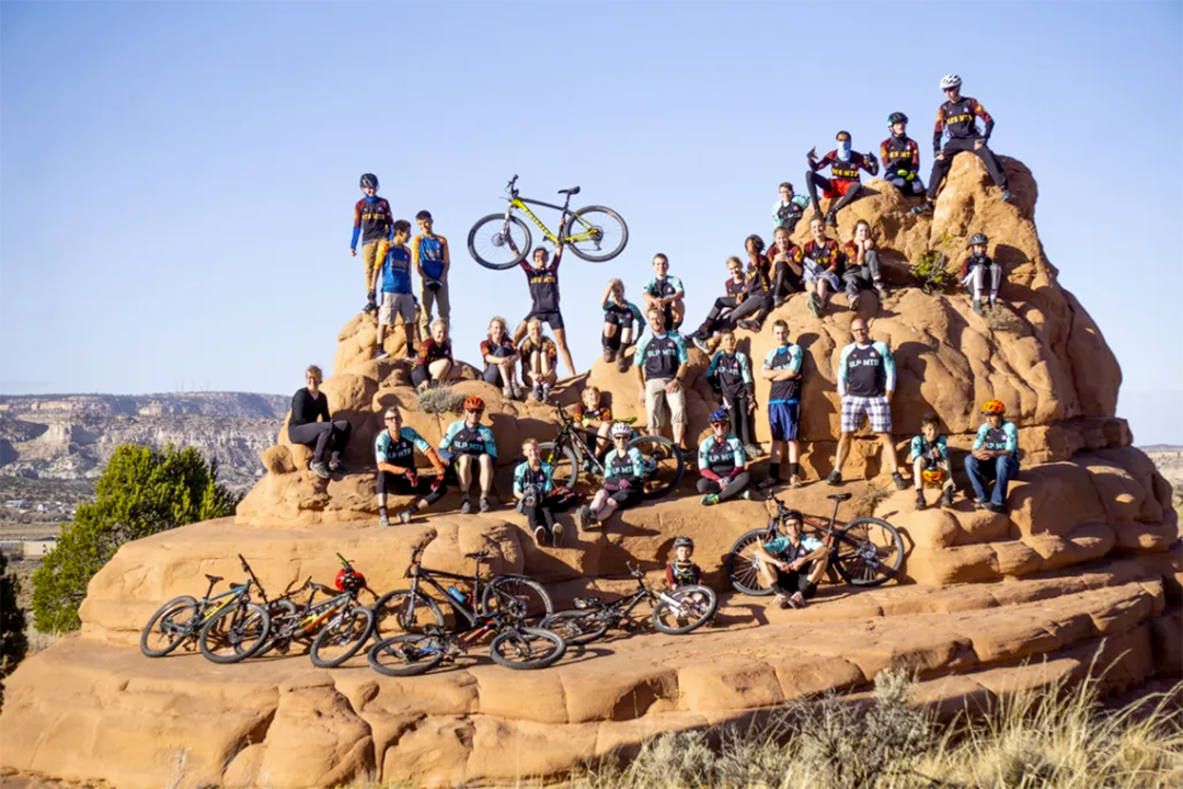 Group photo of Silver Stallion competition team posed on a rock formation.