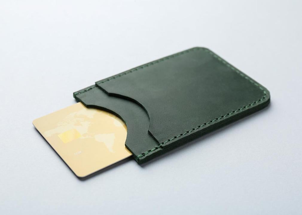 A single card inside a green wallet.