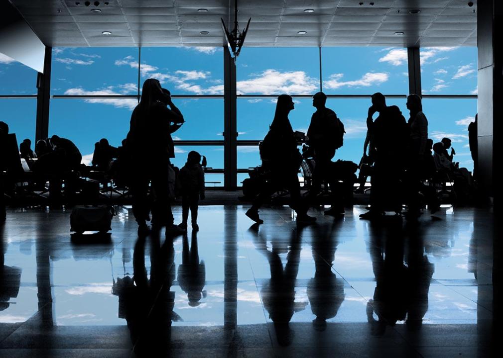 Silhouettes of people inside the airport.