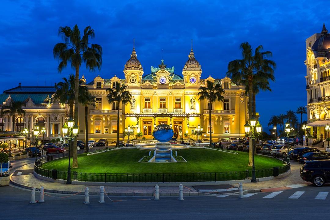 The Monte Carlo Casino, gambling and entertainment complex at twilight in Monte Carlo, Monaco, Cote de Azul.