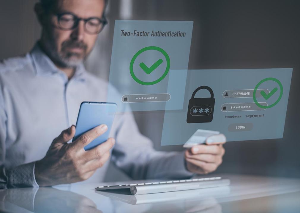 Man holding a phone and his card and illustrated with hologram two-factor authentication graphics.