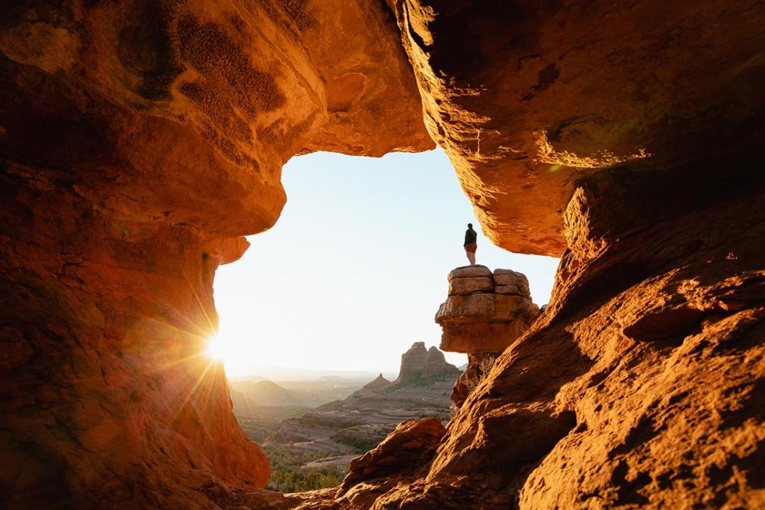 Dramatic viewpoint at Merry-go-round Rock in Sedona Arizona at sunset with sun flare.