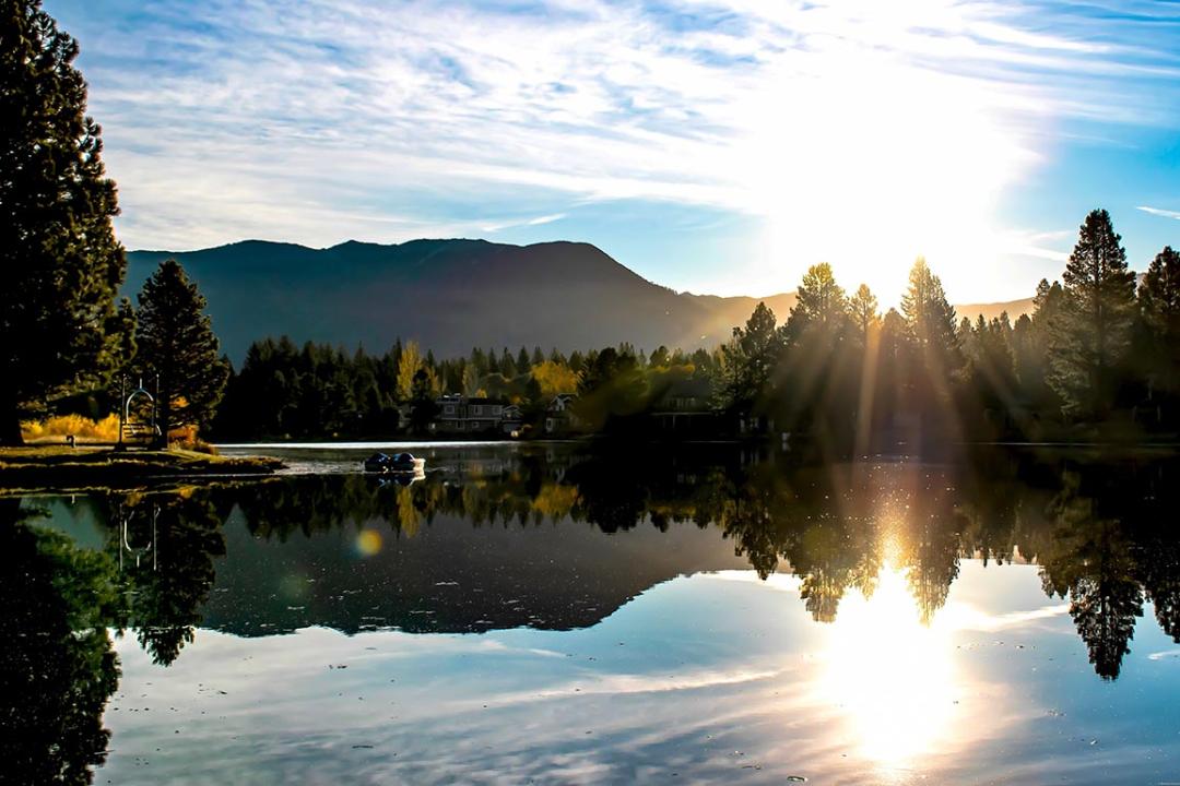 Morning sunrise along Tahoe keys lake with reflecting mountain range in South Lake Tahoe, CA