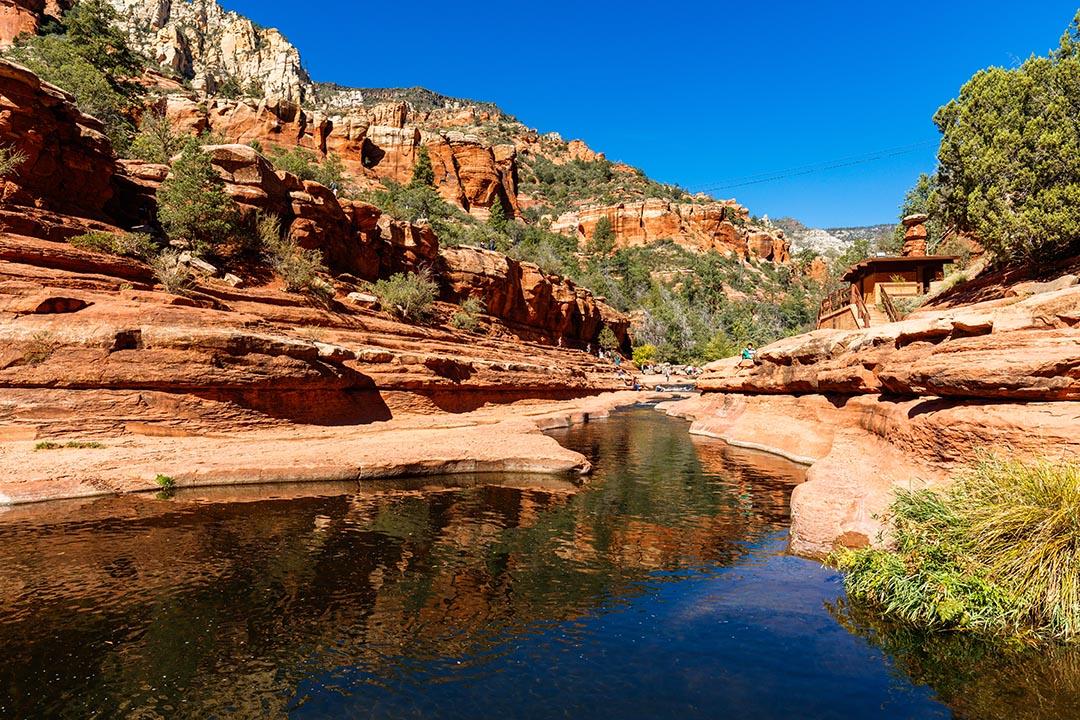 Visitors enjoying the beauty of Slide Rock State Park in October with its natural rock water slides in the Oak Creek Canyon near Sedona.