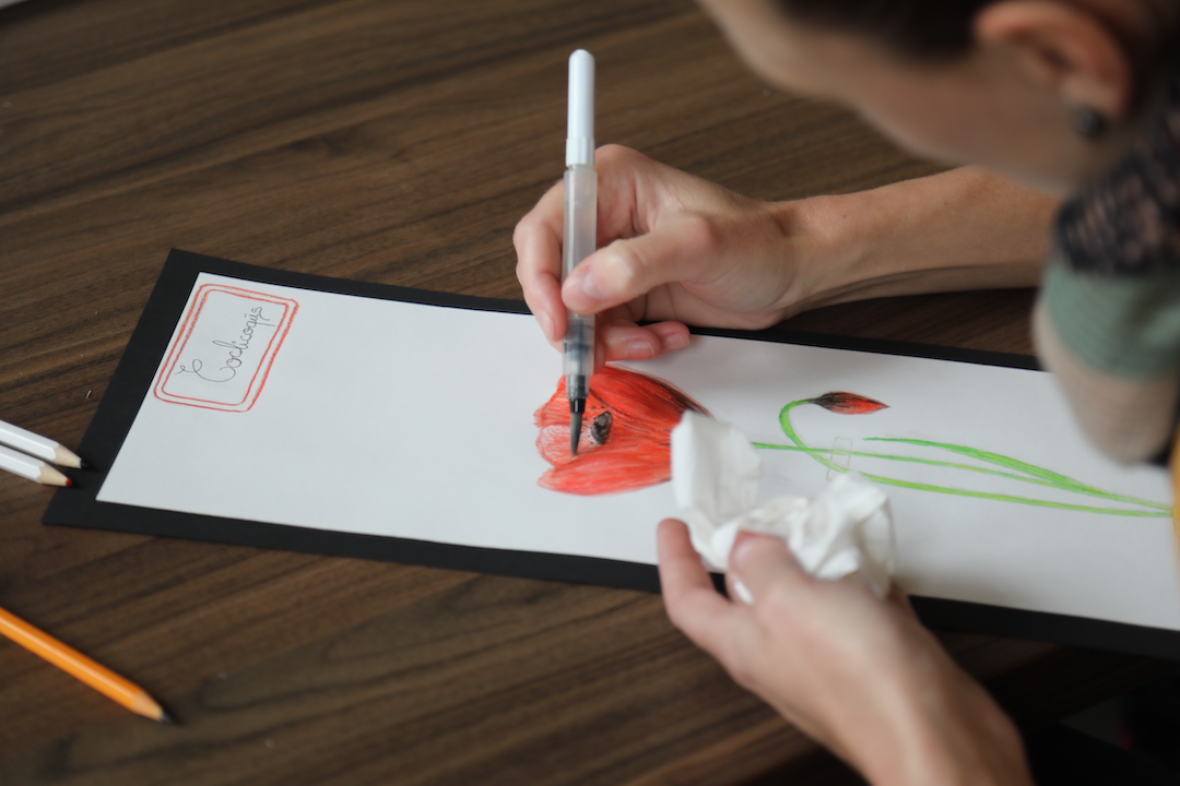 A participant drawing a flower during an art therapy session.