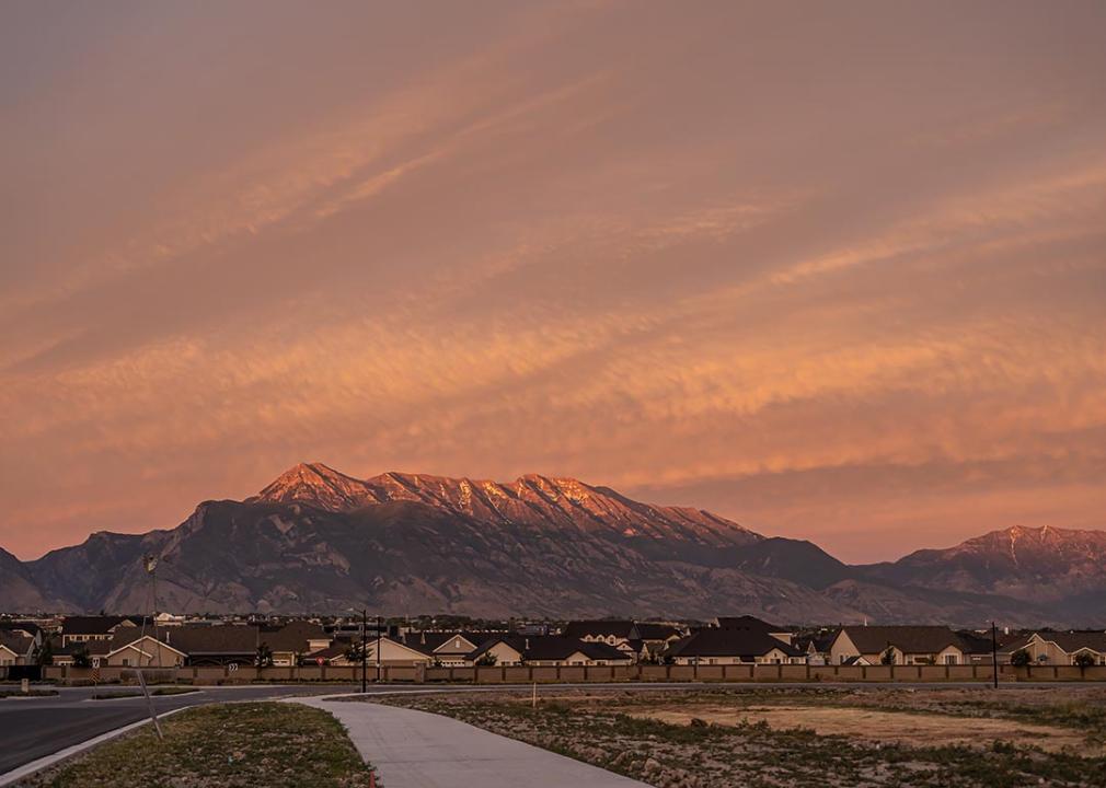 Lehi area new housing development with Utah mountains in background during sunset.