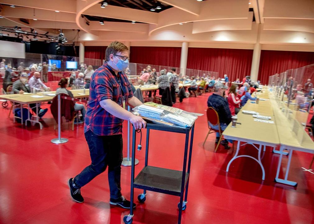 A Dane County Clerk's Office employee transports ballots across the Monona Terrace Convention Center during the county's election recount in Madison, Wisconsin in 2020.