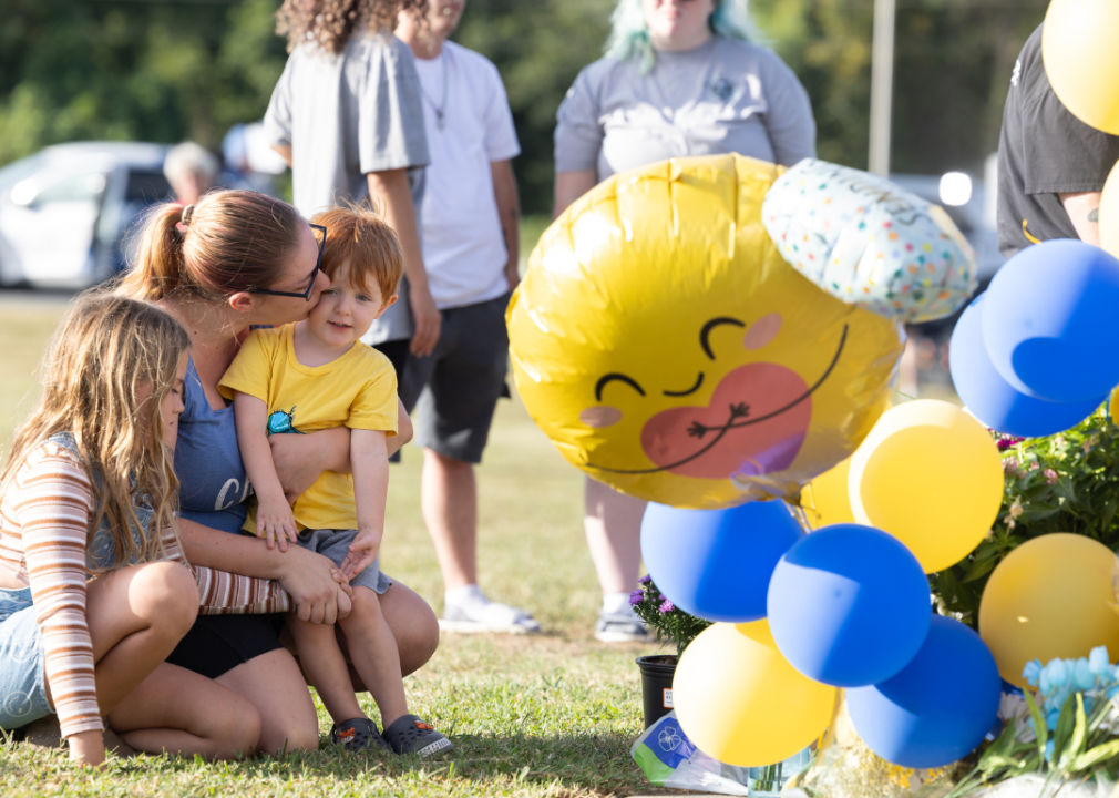 Community members pay their respects at a makeshift memorial outside of Apalachee High School in Winder, Georgia. 