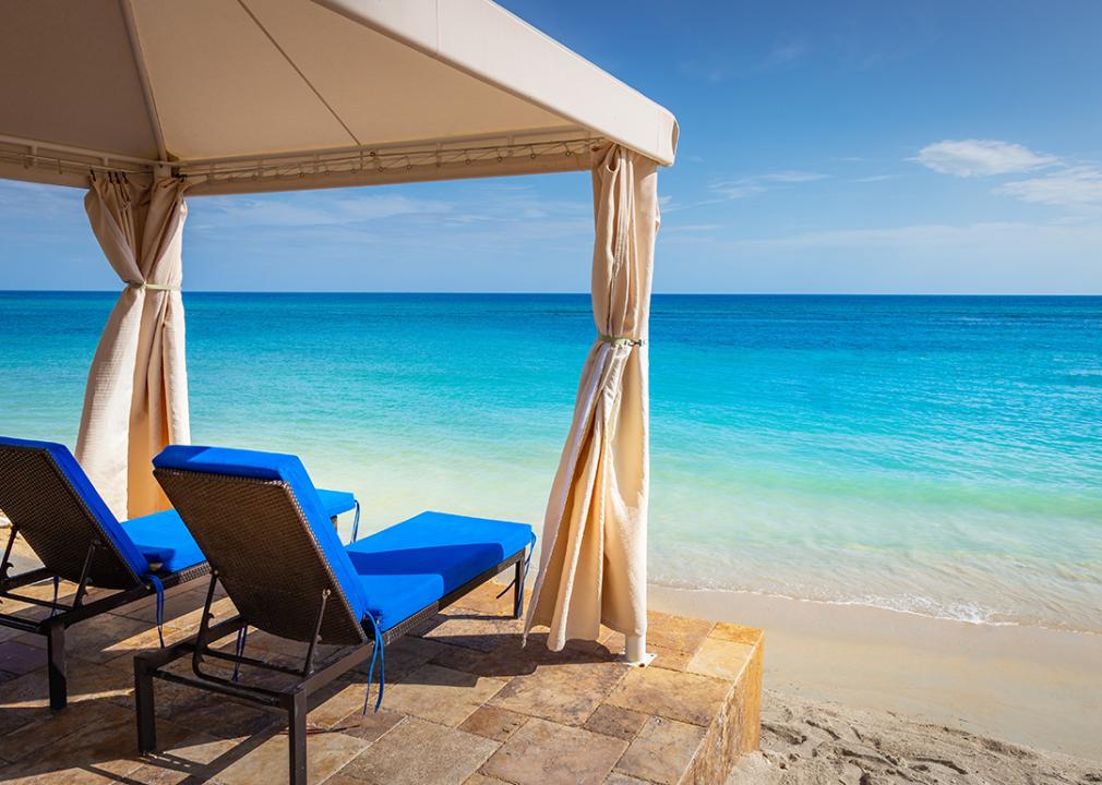 Two chairs set on the pier and gazebo overlooking an idyllic Caribbean beach in Montego Bay, Jamaica.