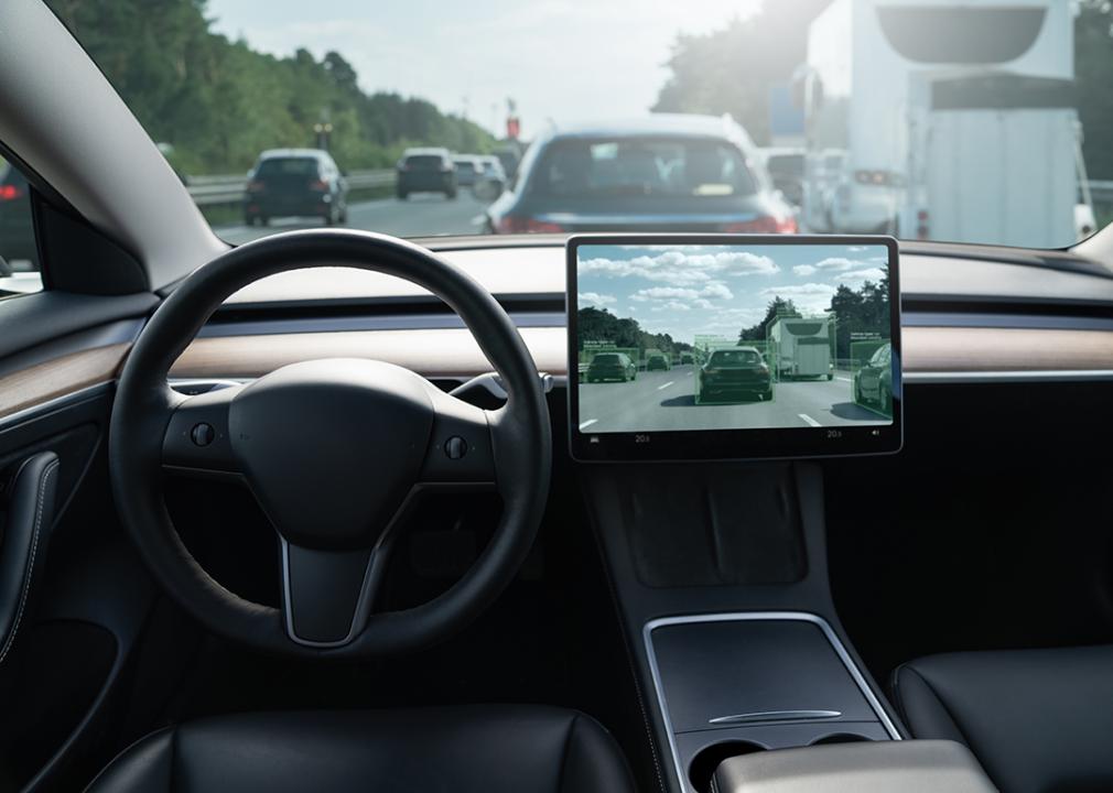 An autonomous car on the road with a display showing how it detects nearby cars and their movements.