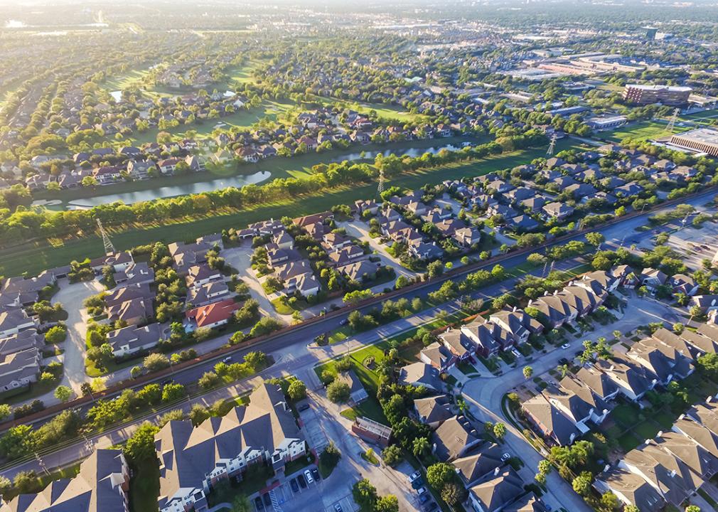 An aerial view of suburban residential houses neighborhood during sunset in Houston, Texas.