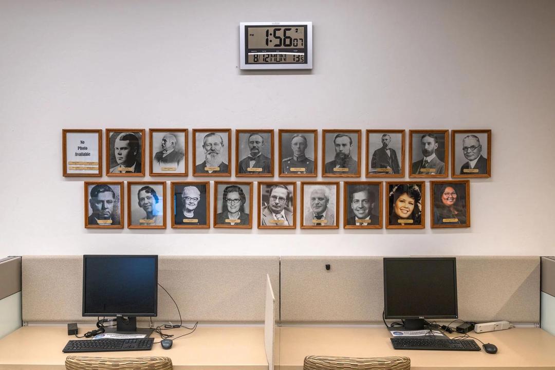 Displays of framed portraits of Pima County Recorders, including Cázares-Kelly, at her offices. 