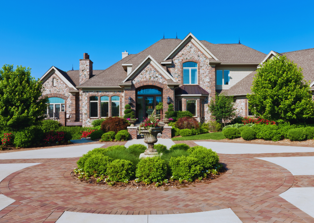 A luxury home with an expansive circular driveway.