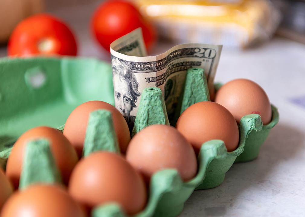 Food inflation concept where a tray of eggs is shown with a 20 dollar bill.