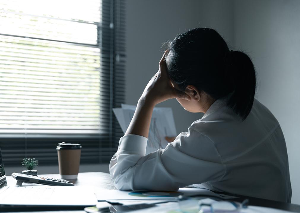 Female employee feeling stressed at work.