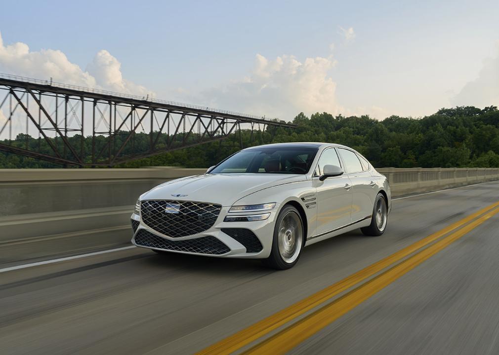 A white 2025 Genesis G80 on the road.