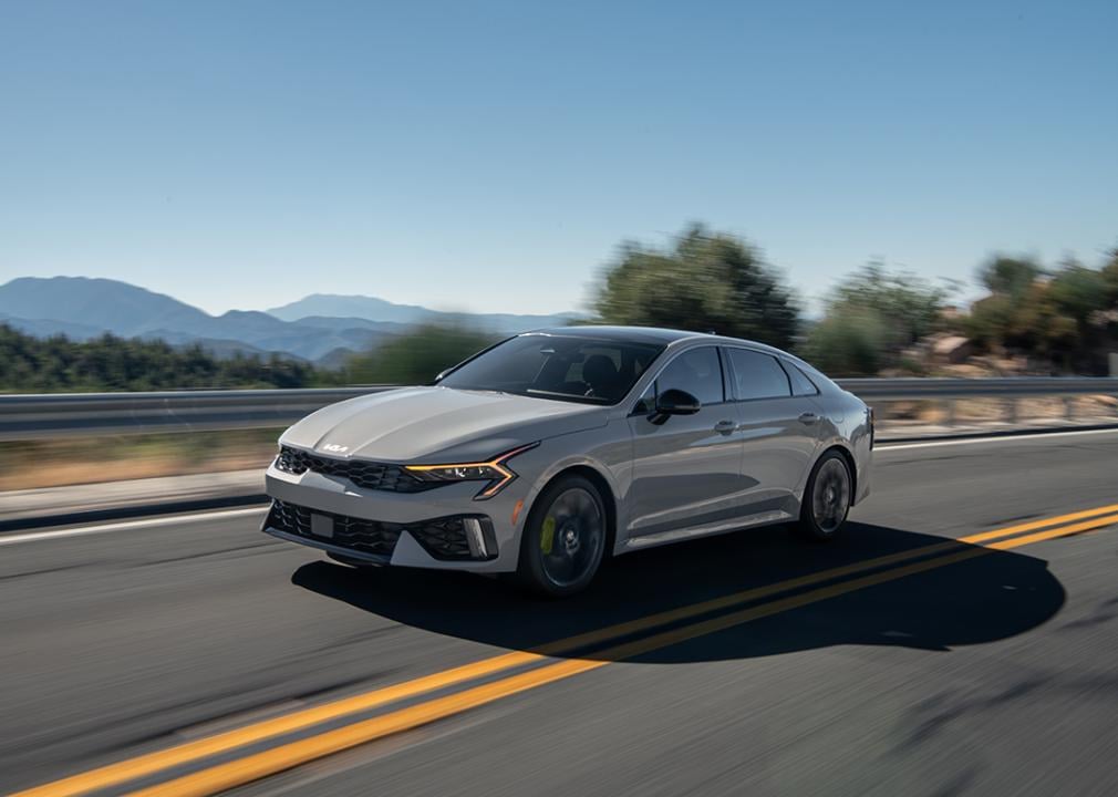 A white 2025 Kia K5 on the road.