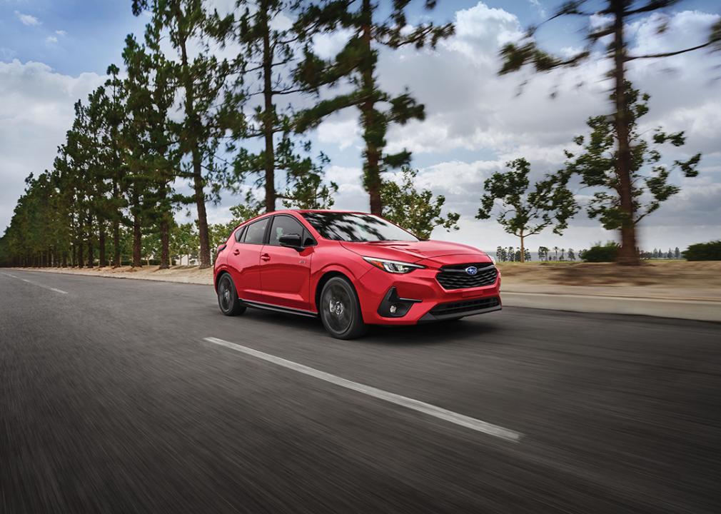 A red 2025 Subaru Impreza on the road.