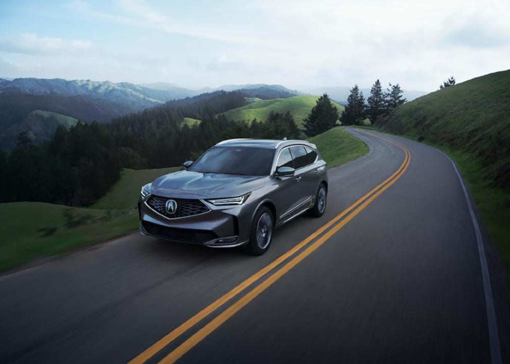 A 2025 black Acura MDX on the road.