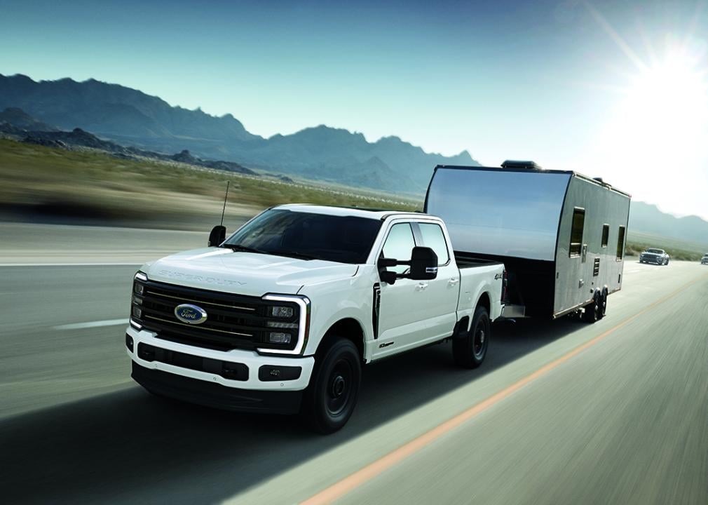 A front view of a white 2025 Ford F-350 Super Duty on the road.