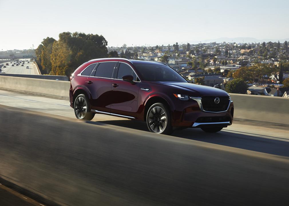 A 2025 red Mazda CX-90 on the road.