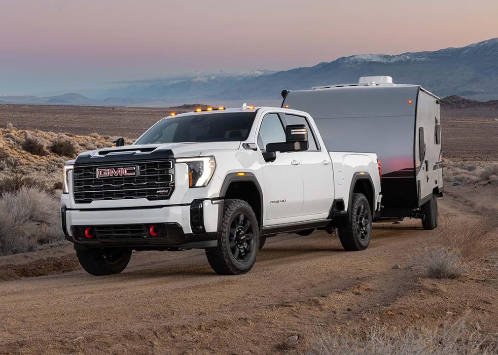 A front view of a white 2025 GMC Sierra 3500HD on the road.