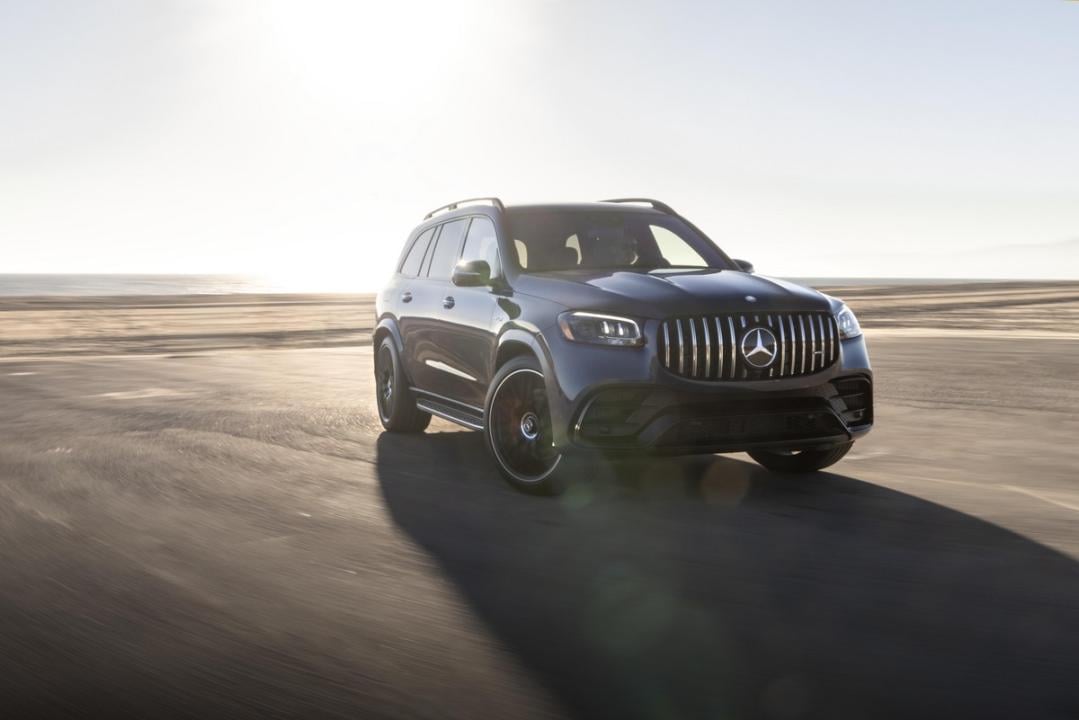 Dark Mercedes GLS on a dusty road.