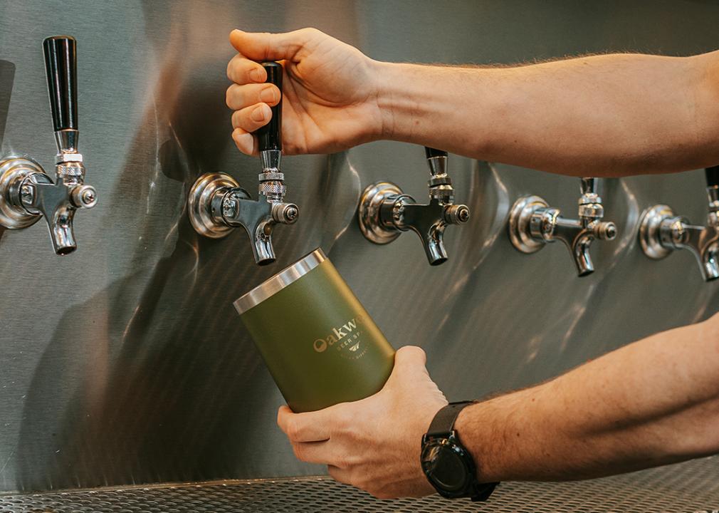 Staff pouring beer in an Oakwell cup.