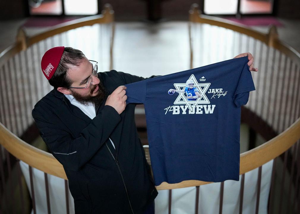 Rabbi Avremi Zippel holds up a BYU shirt.