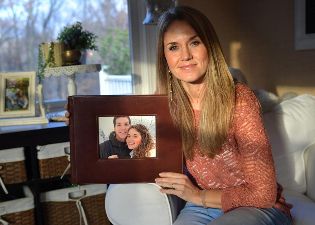 Emily Sanchez showing a framed photograph of her and her late husband.