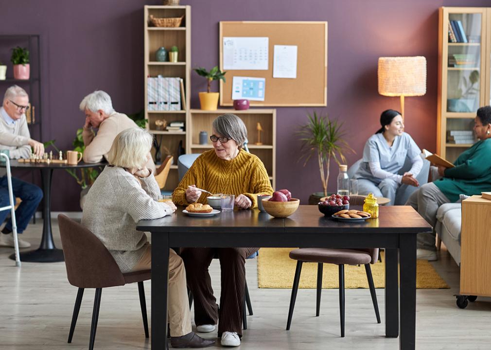 A group of seniors engaging in recreational activities in an assisted living facility.