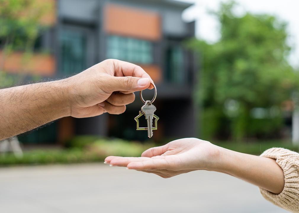 A woman being handed the keys to her first home.