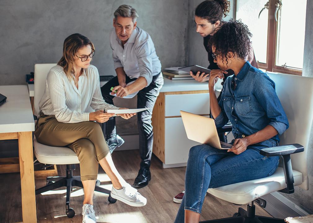 A diverse group of entrepreneurs engaged in a project plan discussion.