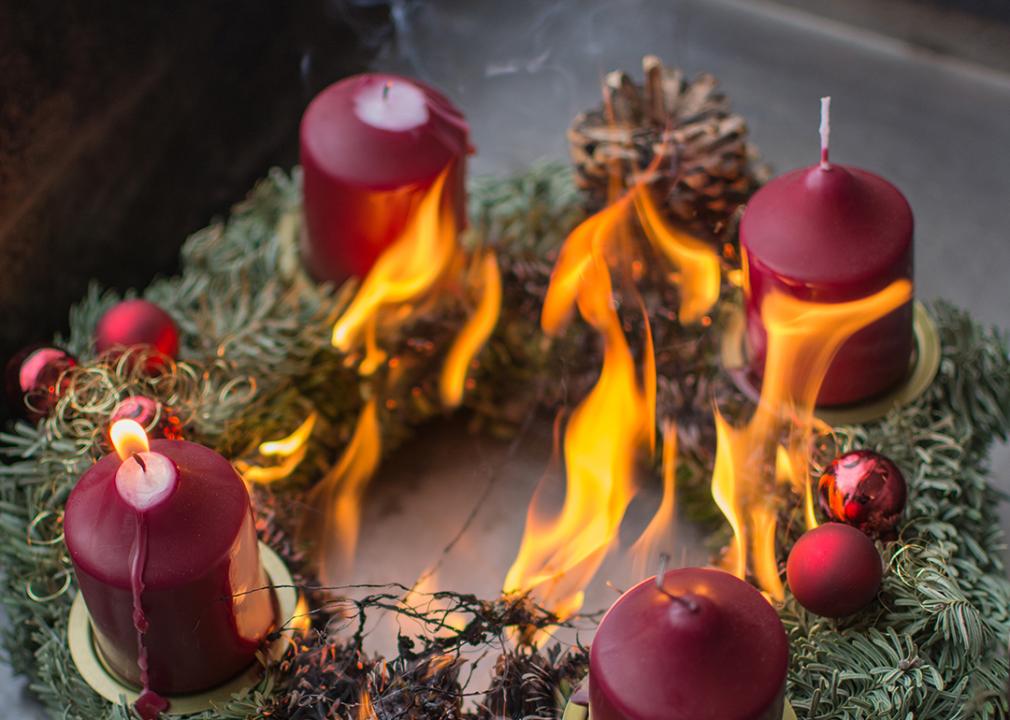 A Christmas wreath getting caught on fire from candles.