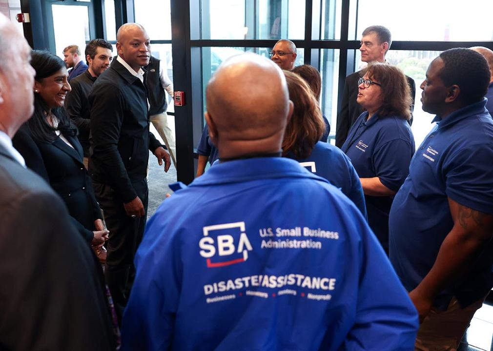 Workers at the Small Business Administration’s Business Recovery Center in Maryland talking to Governor Wes Moore.