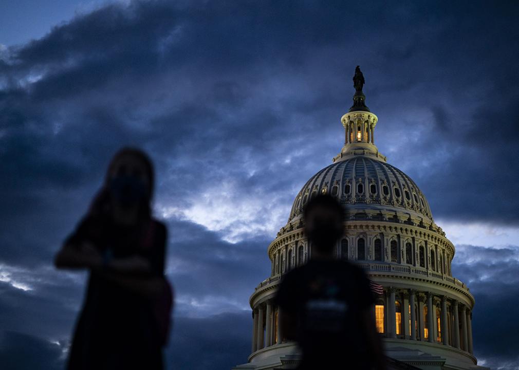 Silhouette of children in front of the Capitol Dome during sunset on Capitol Hill in Washington, DC.