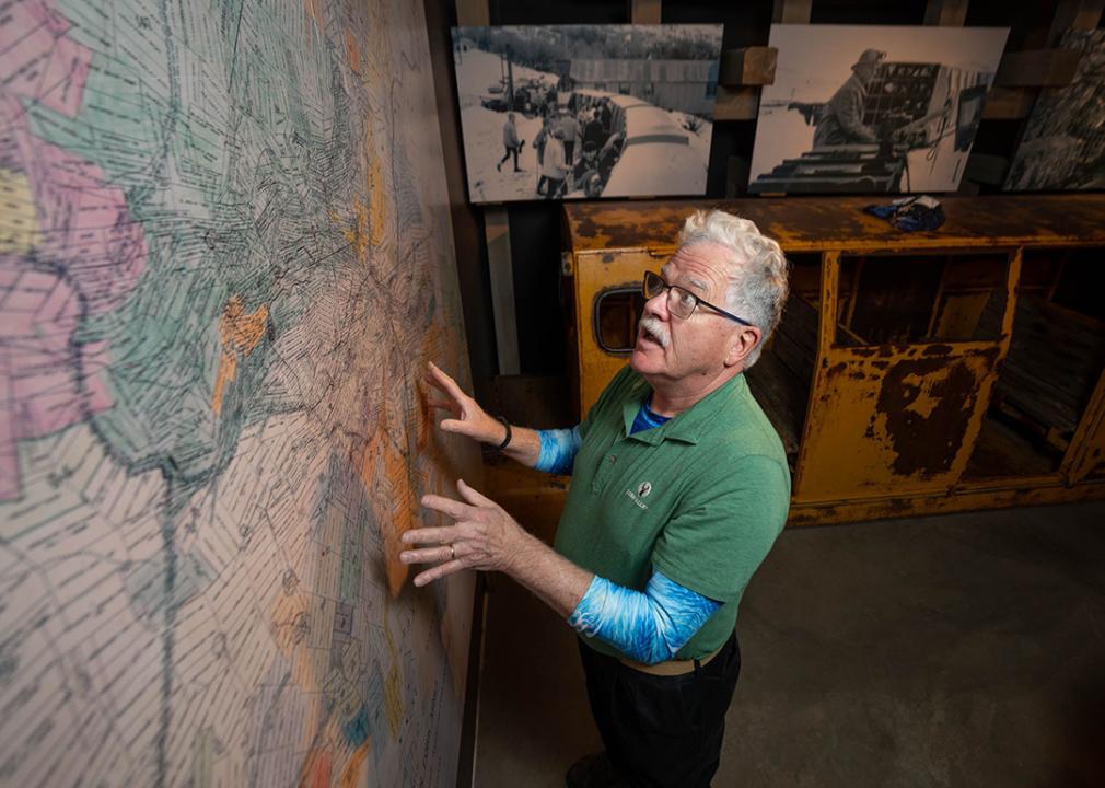 Michael O'Malley is a mountain host at Deer Valley Resort and also a history buff who volunteers at the Park City Museum, looks at a large map of mining claims at the museum.