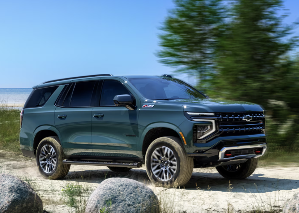 A dark green 2025 Chevy Tahoe on roadside.